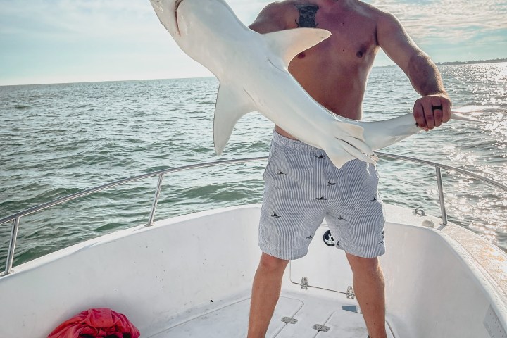 a man riding a skateboard up the side of the water