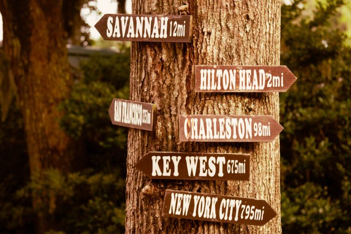 a close up of a street sign on a wooden pole
