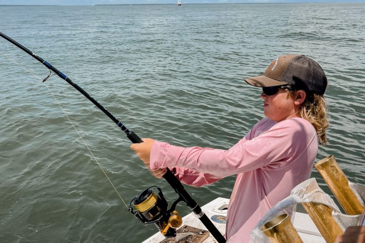 a person standing next to a body of water