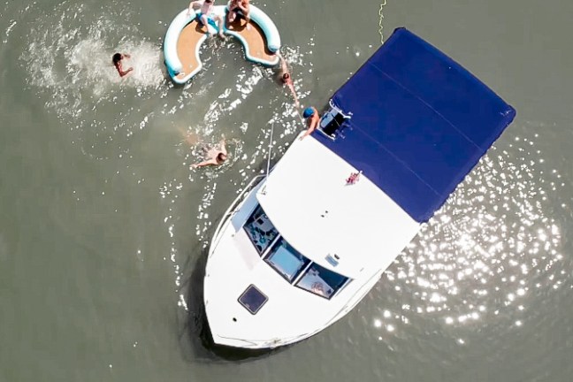 a man flying through the air while riding a surfboard in the water