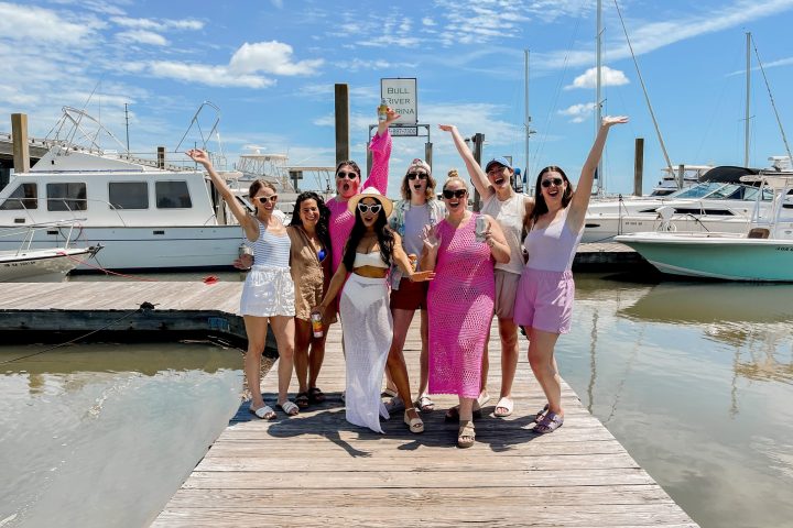 a group of people standing on a boat in the water