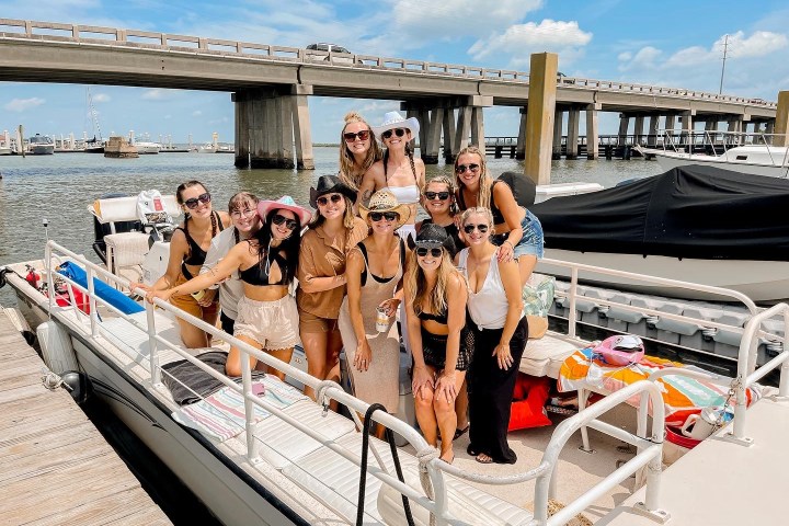 a group of people sitting at a dock