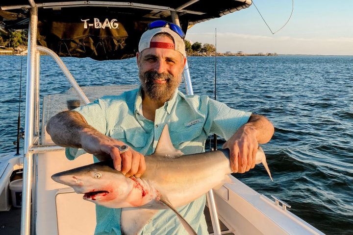 a person sitting in a boat on a body of water