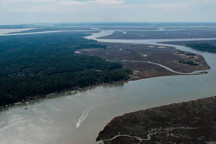a view of a body of water with a mountain in the ocean