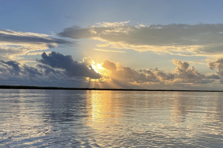 a group of clouds in the sky over a body of water